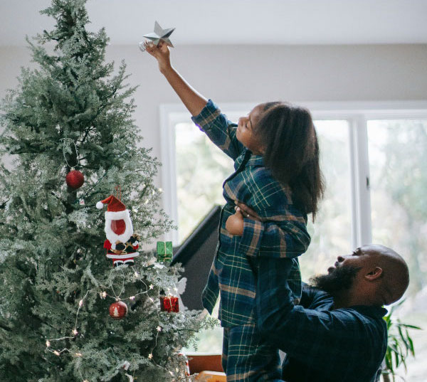 Image of mother pouring hot fresh water into child's mug in the outdoor winter.