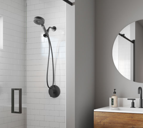 Nebia Yuba 5-Setting Handshower with HaloNetic Double Docking System in matte black, mounted in a modern white tile shower, delivering a sleek, eco-friendly upgrade
