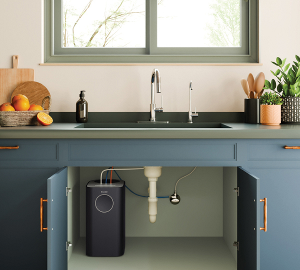 Modern bathroom with white toilet and bidet control, soft beige walls, shower with warm tile, shelf with plants and candles, creating a clean, spa-like atmosphere calm tones!