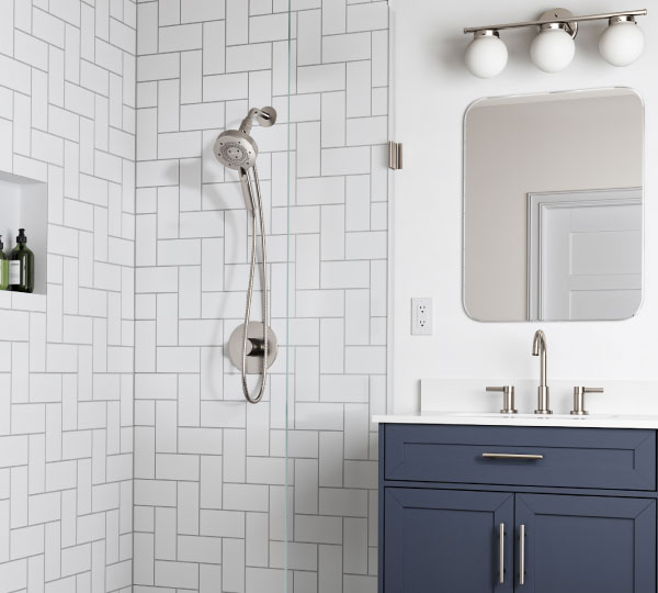 Bright modern kitchen with large windows and island sink featuring Jema Single-Handle Pull-Down Kitchen Faucet in brushed finish beneath stylish pendant lighting.