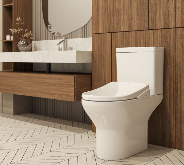 Coit Integrated Smart Bidet Toilet in a contemporary bathroom with green tile walls, glass shower enclosure, floating vanity, and clean, minimalist styling.