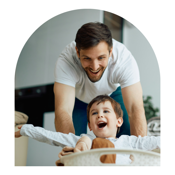 Dad holding his child while smiling.