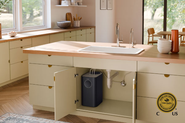Circle Reverse Osmosis Under Sink Water Filtration System installed beneath a modern kitchen island sink. Water Quality Association Gold Seal certification badge shown.