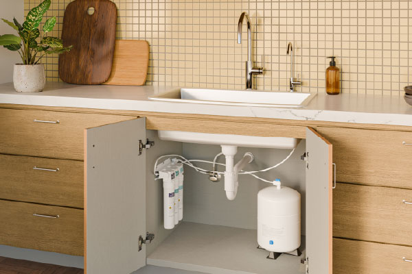 RC250 Capella Reverse Osmosis Water Filtration System installed beneath a modern kitchen sink, delivering purified drinking water with a compact under-sink design.