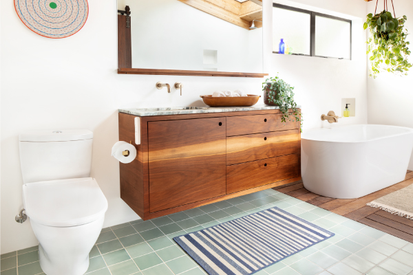 Swash Thinline T44 Luxury Bidet Toilet Seat in a bright bathroom with a wood vanity, green tile floor, and freestanding tub.