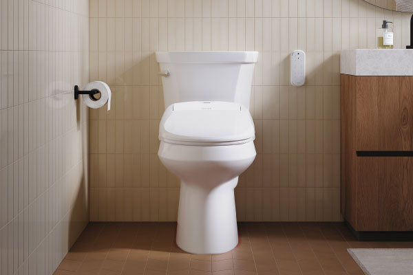 Swash 1400 Luxury Bidet Toilet Seat shown from the front on a white toilet in a contemporary bathroom, featuring a...